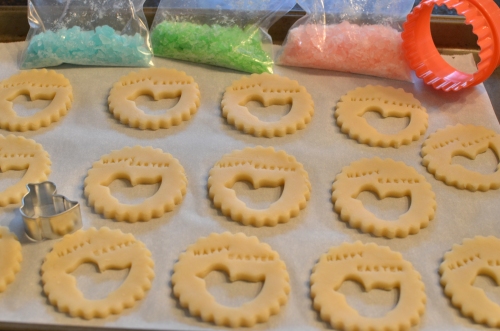 Preparing cookies with cookie cutters and alphabet stamps, then add crushed hard candies after